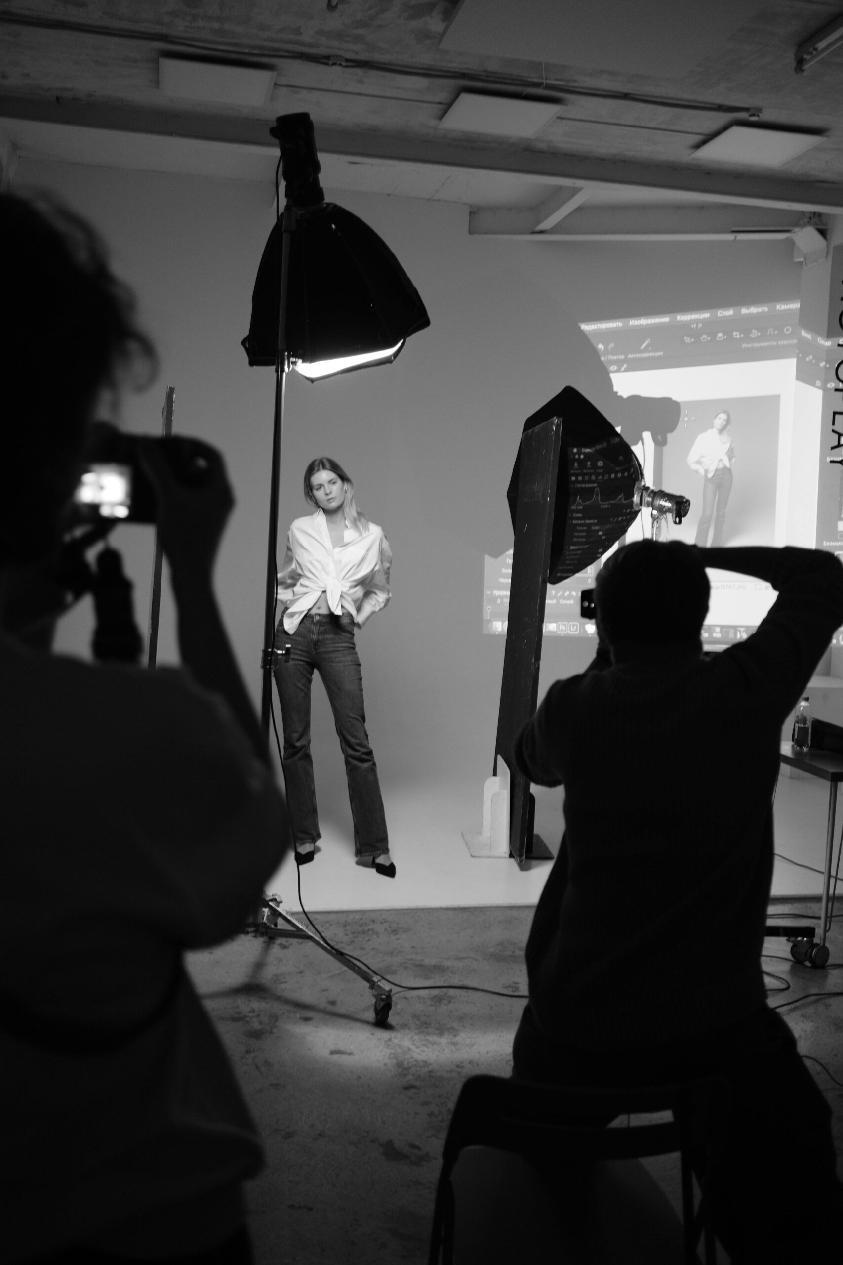 Studio photoshoot featuring a female model being photographed under professional lighting, representing a high-end editorial fitness brand.